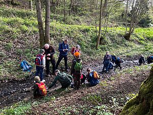 Eine Gruppe Kinder erforscht einen Bach